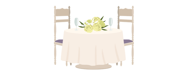 花とシャンパングラスが置かれたテーブルと椅子