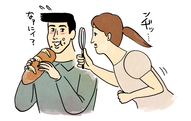 パンを食べる男性を虫眼鏡でまじまじと見る女性