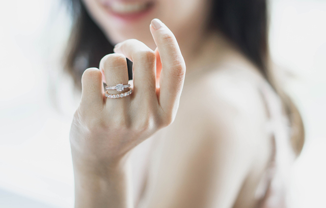 婚約指輪と結婚指輪を重ねづけしている女性