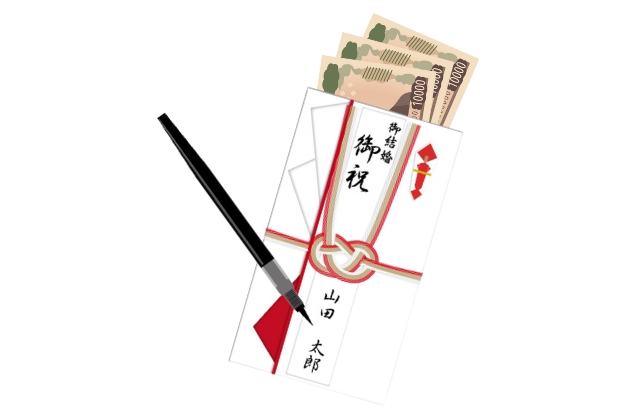 筆ペンでご祝儀袋に記入している様子