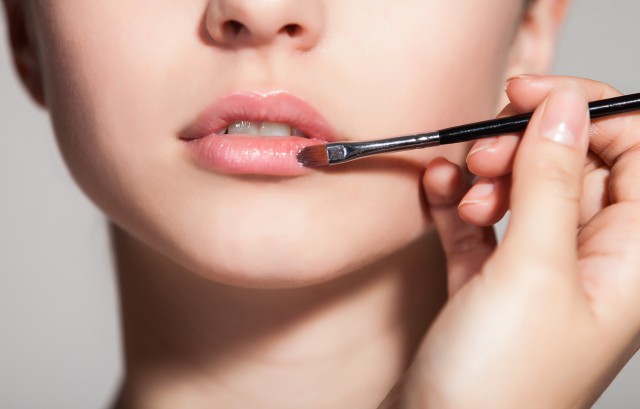 紅筆を使って口紅を塗す様子