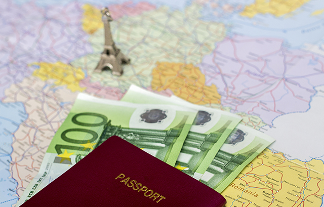 地図の上のユーロ紙幣とパスポート