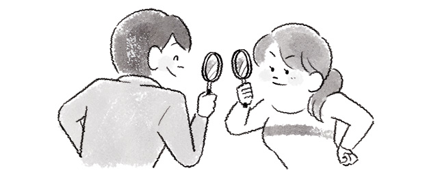 お互いを虫メガネで見つめ合うカップル