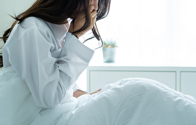 体調不良の女性