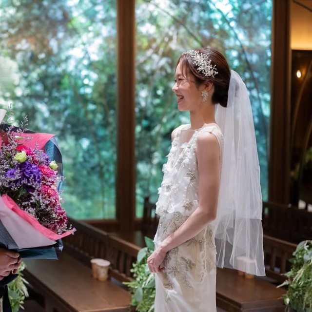 ミディアムベールをつけた花嫁と花束を持つ新郎