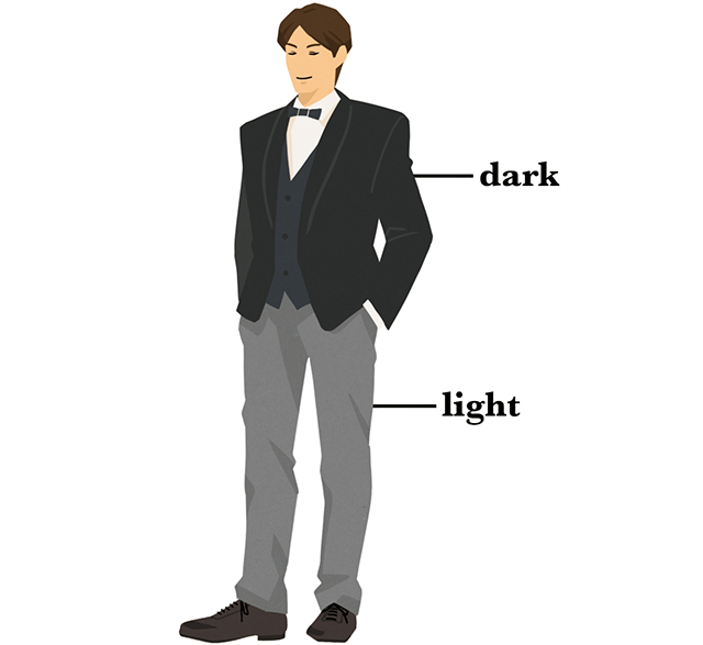 暗めのジャケットと明るめのパンツを着た男性