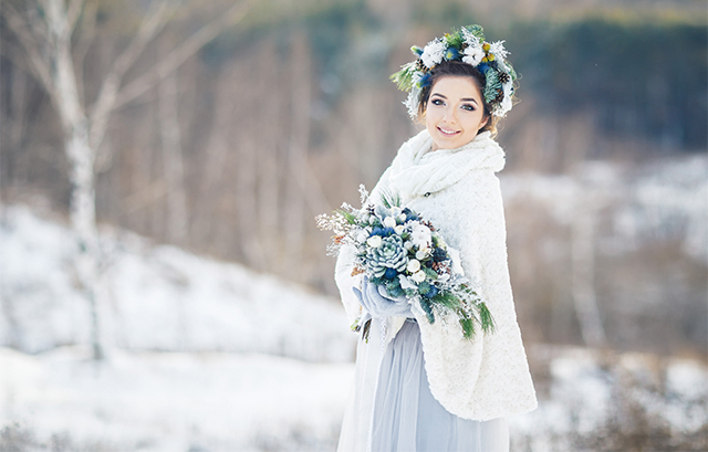 冬景色を背景にしたブーケを持つ花嫁