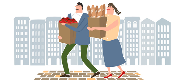 袋に入ったトマトとパンを抱えながら街歩きをするカップル